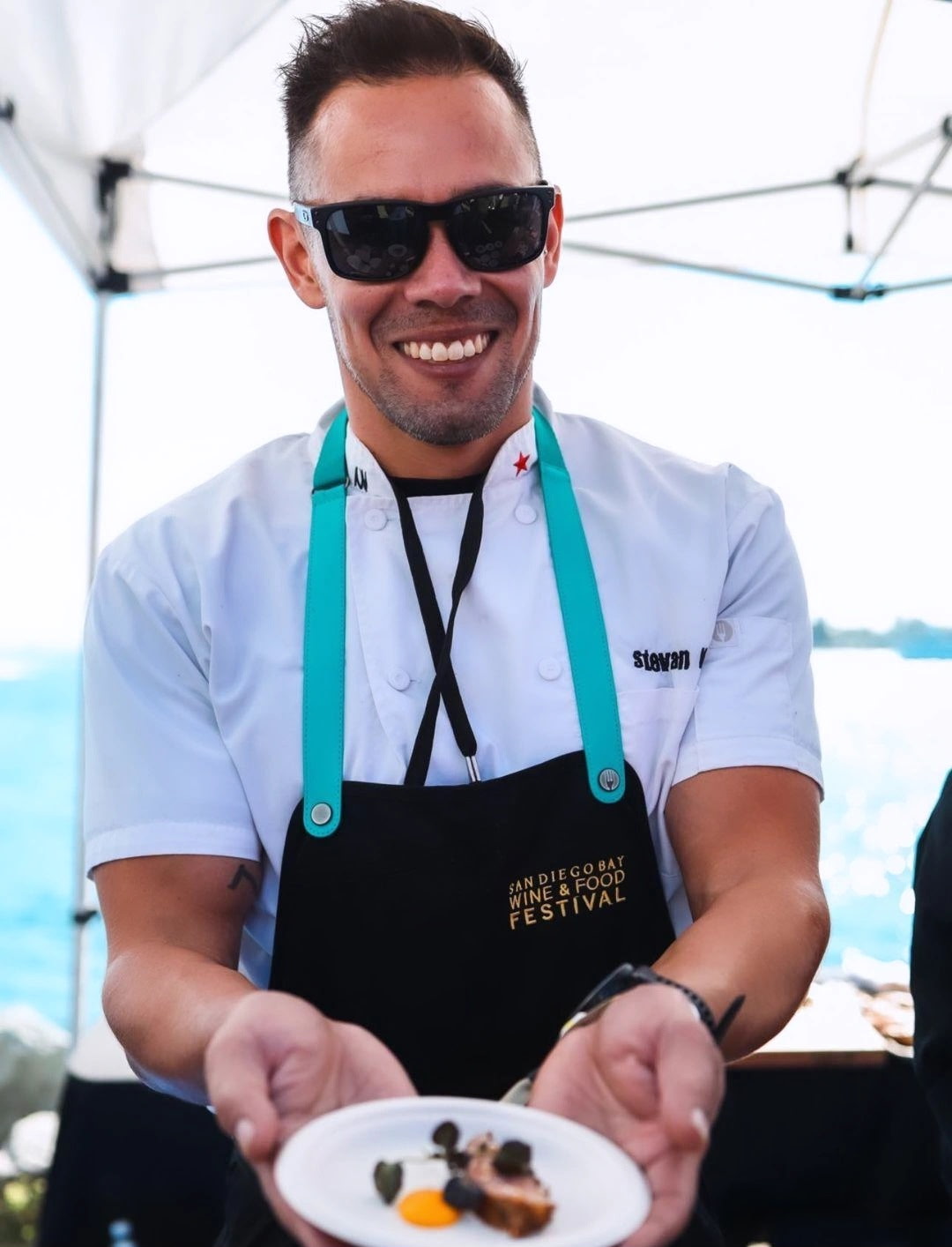 Chef Stevan serving a plate at a food festival